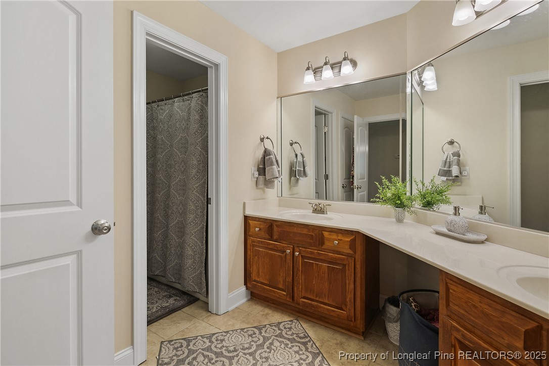 256 Barons Run West Spring Lake, NC 28390 - Photo 37 of 44 a spacious bathroom with a sink and a mirror