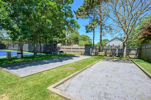 a swimming pool view with a seating space and a garden view