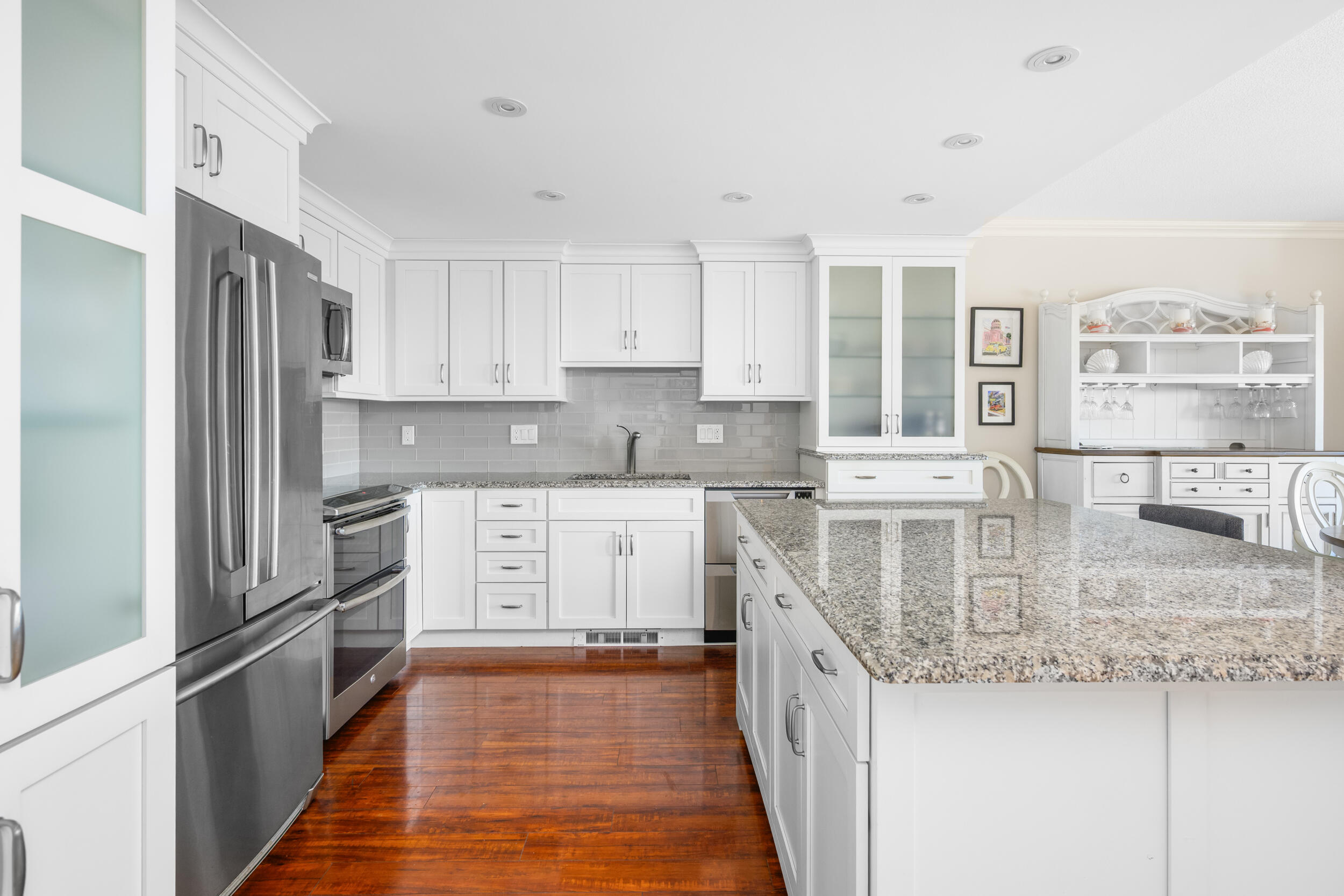 1 Belmont Road, Unit 541 West Harwich, MA 02671 - Photo 4 of 31 a kitchen with stainless steel appliances granite countertop a stove a sink and white cabinets with wooden floor