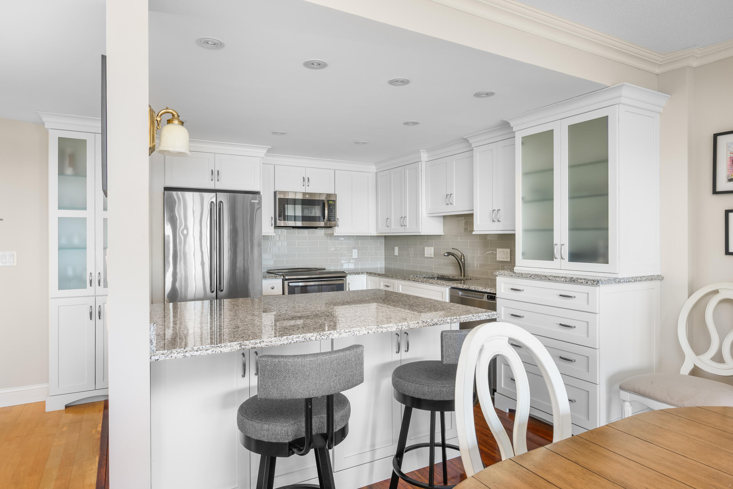 1 Belmont Road, Unit 541 West Harwich, MA 02671 - Photo 5 of 31 a kitchen with stainless steel appliances kitchen island granite countertop a refrigerator a stove a sink dishwasher and white cabinets with wooden floor