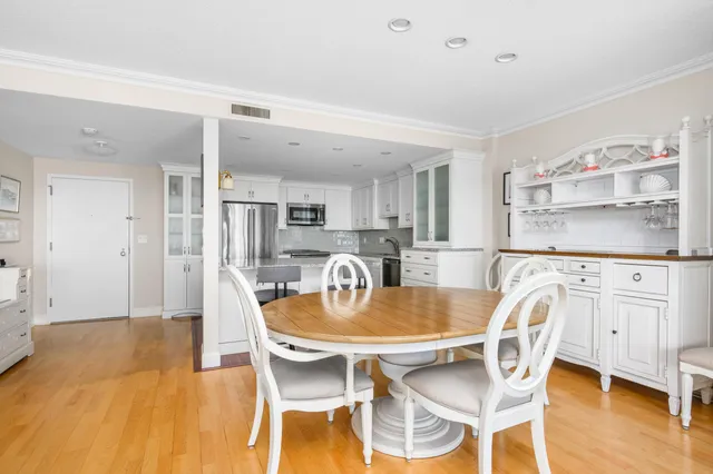 a dining room with kitchen island a table and chairs