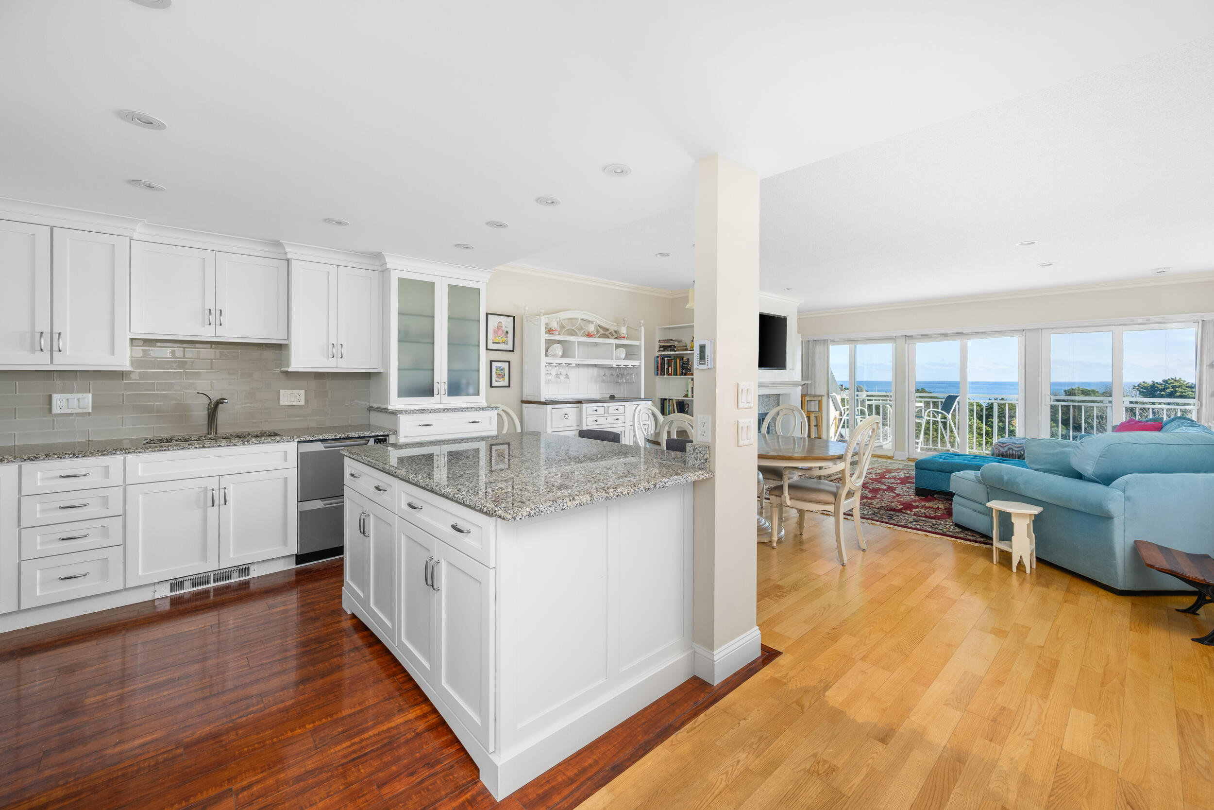 1 Belmont Road, Unit 541 West Harwich, MA 02671 - Photo 6 of 31 a kitchen with stainless steel appliances granite countertop a stove top oven a sink a dining table and chairs with wooden floor