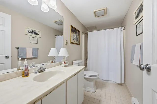 a bathroom with a sink toilet and a mirror