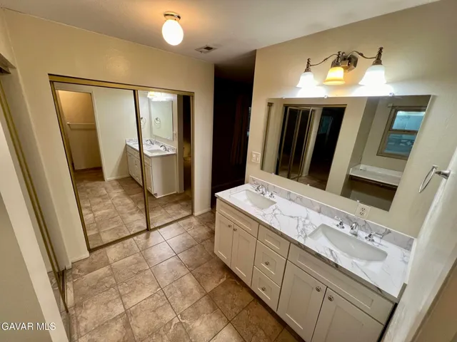a bathroom with a sink and mirror
