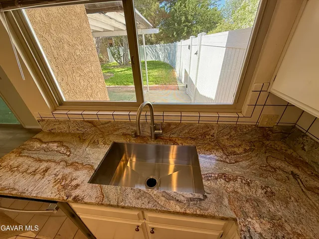 a bathroom with a sink and a window