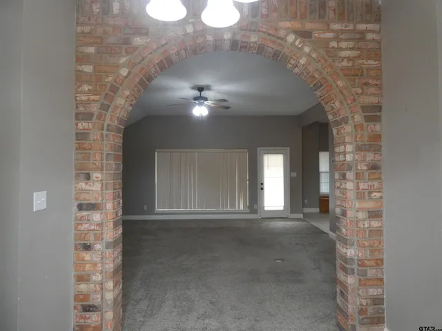 a view of a hallway with brick walls