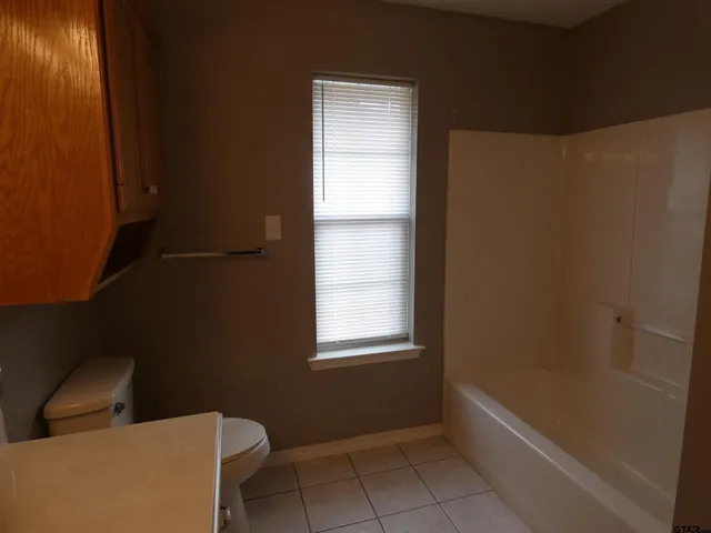 a bathroom with a sink toilet and mirror