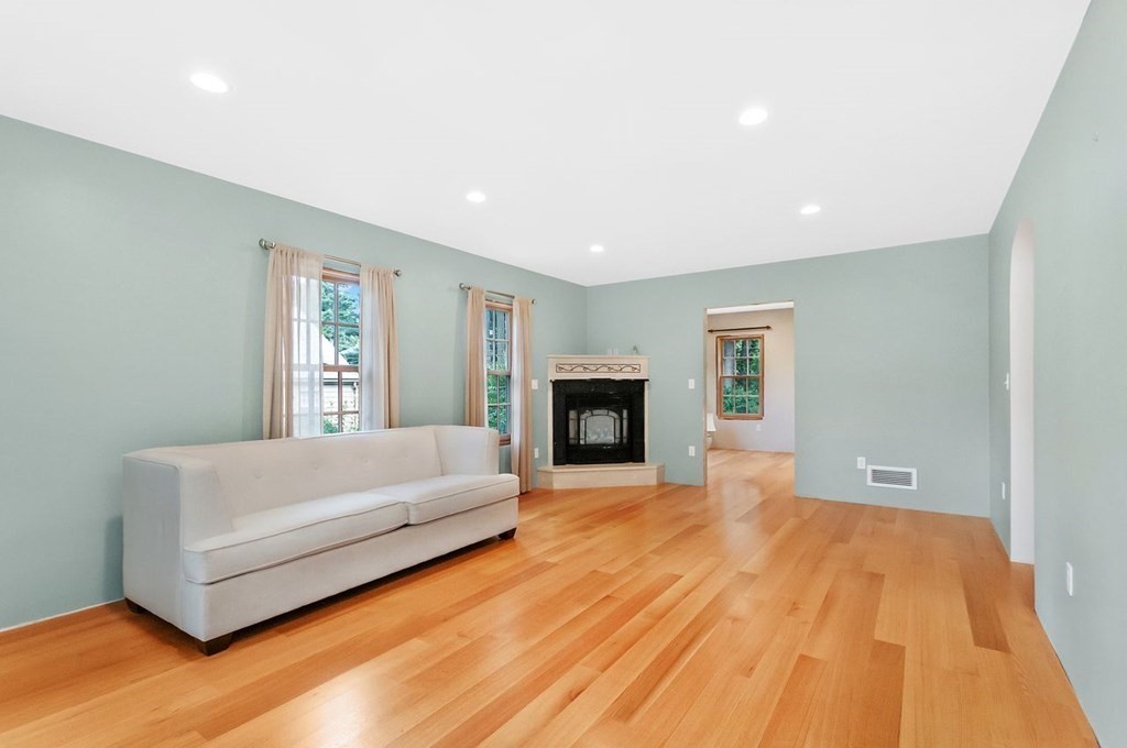 16 Vesta Road Natick, MA 01760 - Photo 11 of 36 a spacious bedroom with a bed and a fireplace