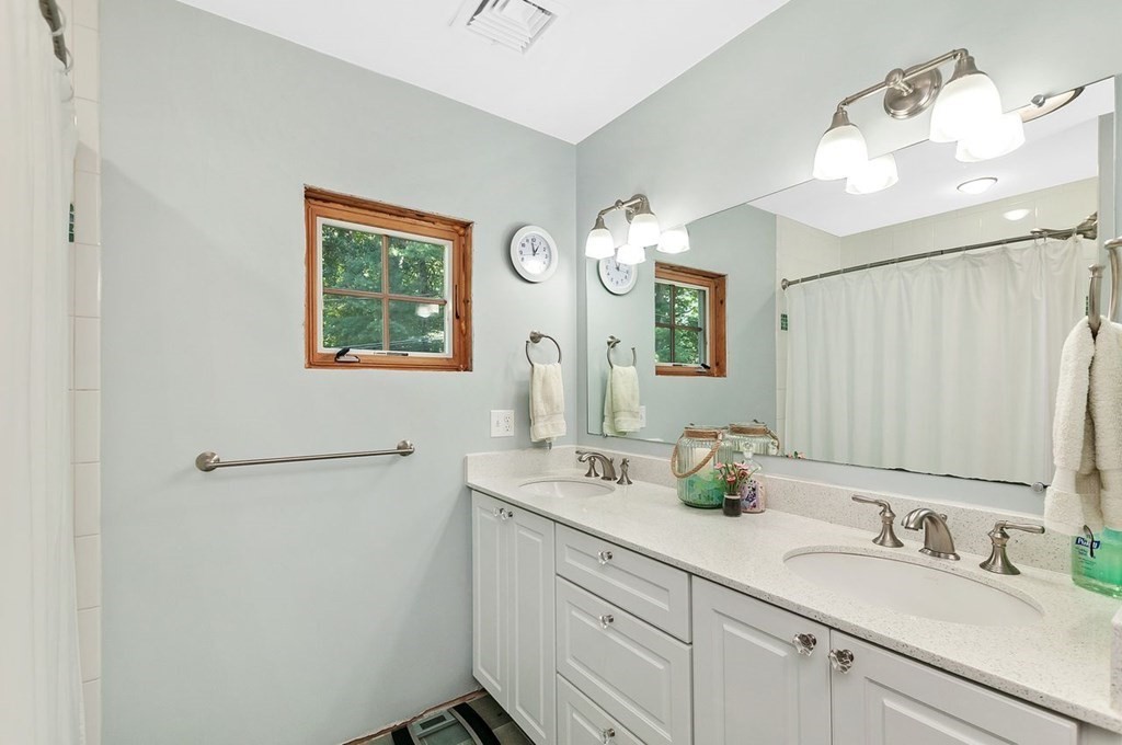 16 Vesta Road Natick, MA 01760 - Photo 20 of 36 a bathroom with a double vanity sink and a mirror
