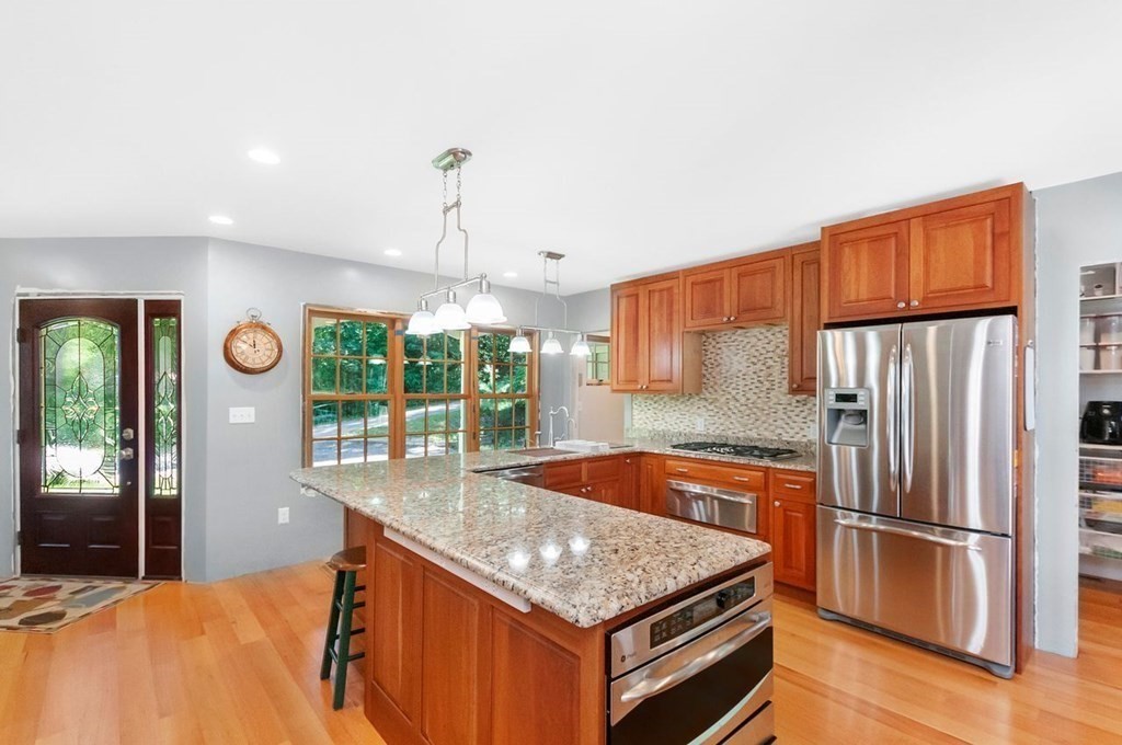 16 Vesta Road Natick, MA 01760 - Photo 2 of 36 a kitchen with stainless steel appliances granite countertop a sink a stove and a refrigerator