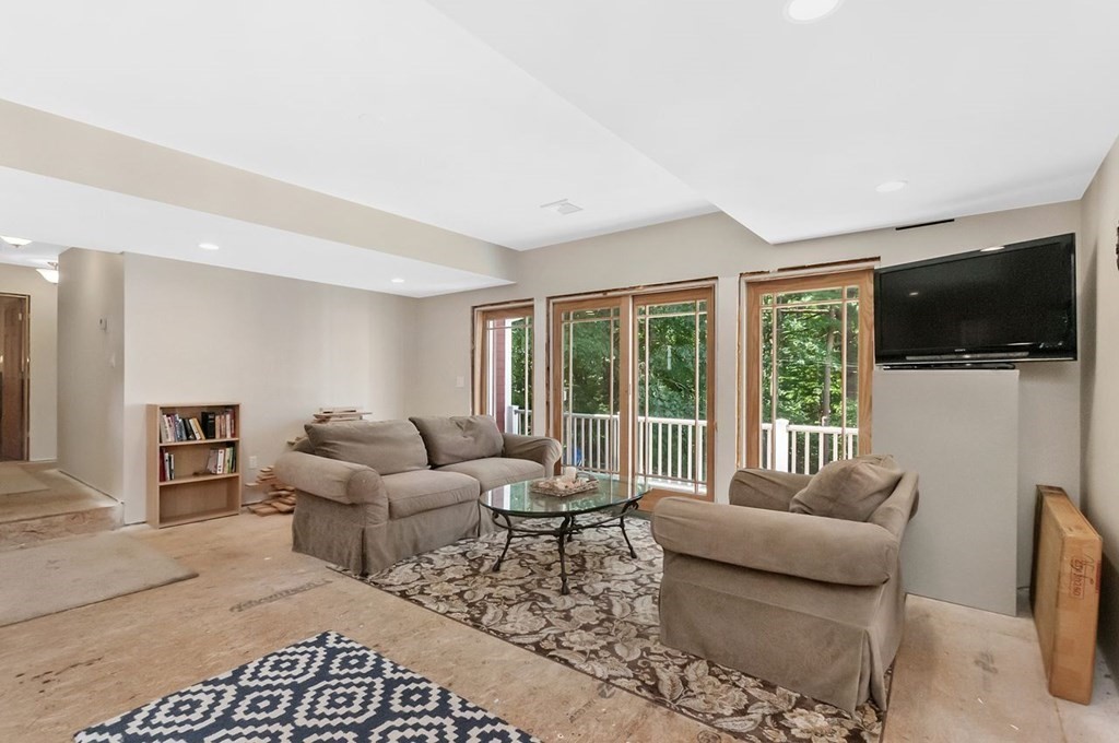 16 Vesta Road Natick, MA 01760 - Photo 26 of 36 a living room with furniture a flat screen tv and a large window