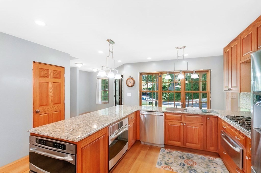 16 Vesta Road Natick, MA 01760 - Photo 3 of 36 a kitchen with a stove a sink and a wooden cabinets
