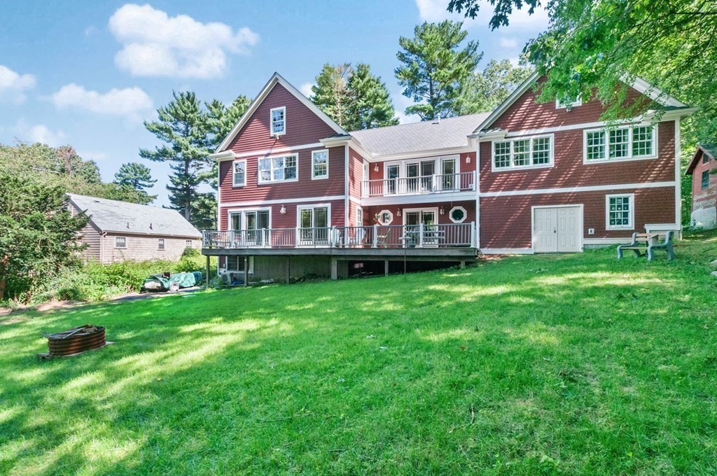 16 Vesta Road Natick, MA 01760 - Photo 33 of 36 a front view of a house with a garden and plants