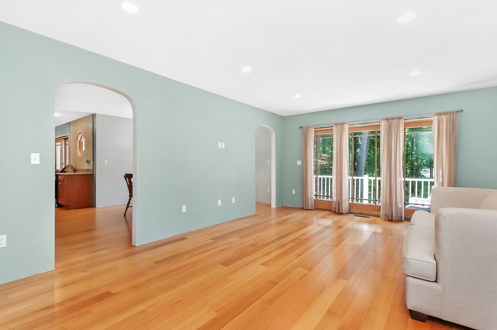 16 Vesta Road Natick, MA 01760 - Photo 8 of 36 a view of a livingroom with wooden floor and a fireplace