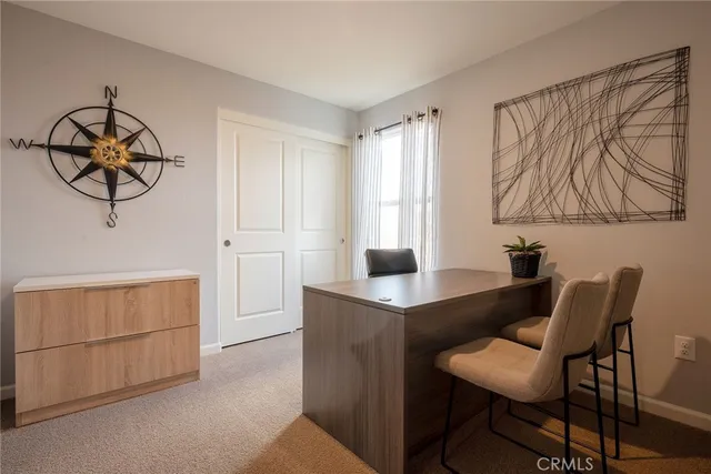 a view of a hallway with wooden floor and glass top table