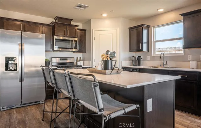 a kitchen with a sink stainless steel appliances and cabinets