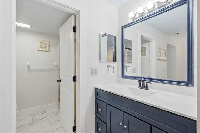 a bathroom with a sink a mirror and shower