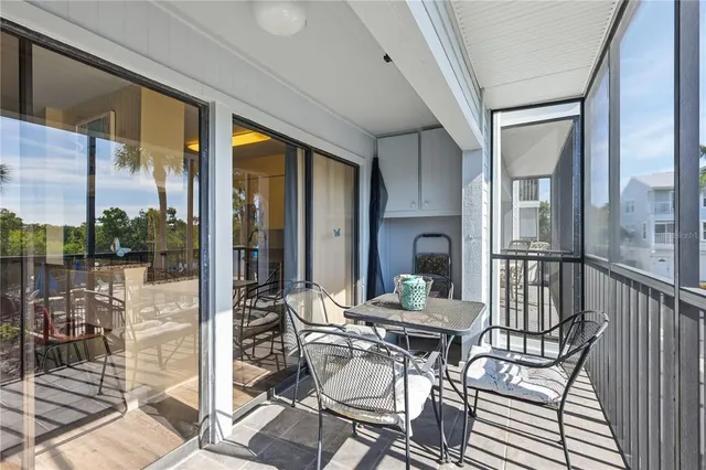 a view of a balcony with potted plants and palm tree