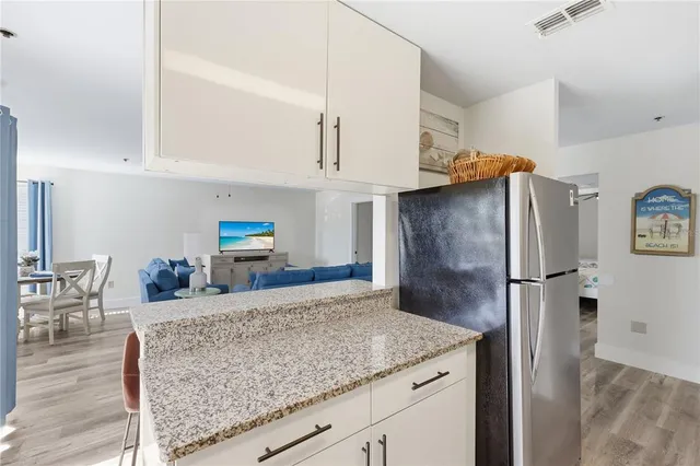 a kitchen with stainless steel appliances granite countertop a refrigerator and a sink