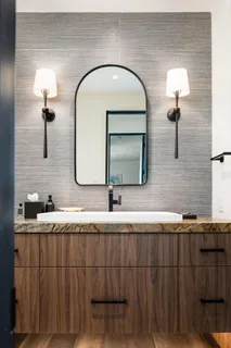 a bathroom with a double vanity sink and a mirror