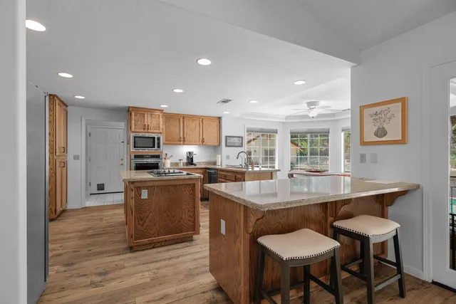 a kitchen with kitchen island a sink table and chairs