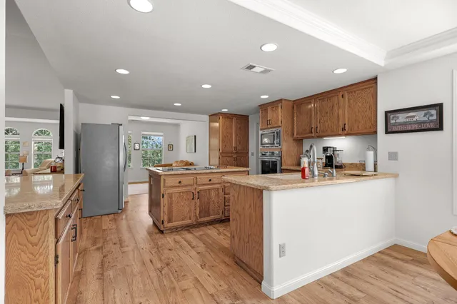 a kitchen with sink a microwave and refrigerator
