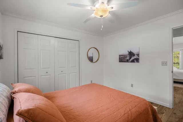 a bedroom with a bed and a chandelier