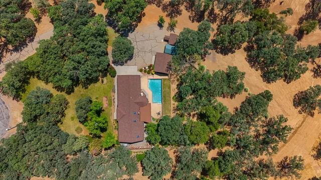 an aerial view of a house with a yard