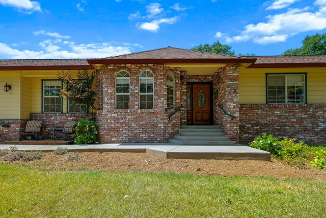 a front view of a house with garden