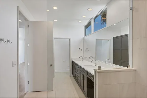 a bathroom with a double vanity sink and a mirror