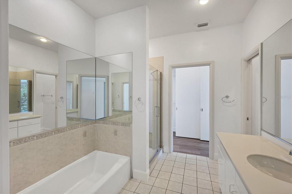 5801 Gulf Of Mexico Drive Longboat Key, FL 34228 - Photo 23 of 52 a bathroom with a bathtub and a shower