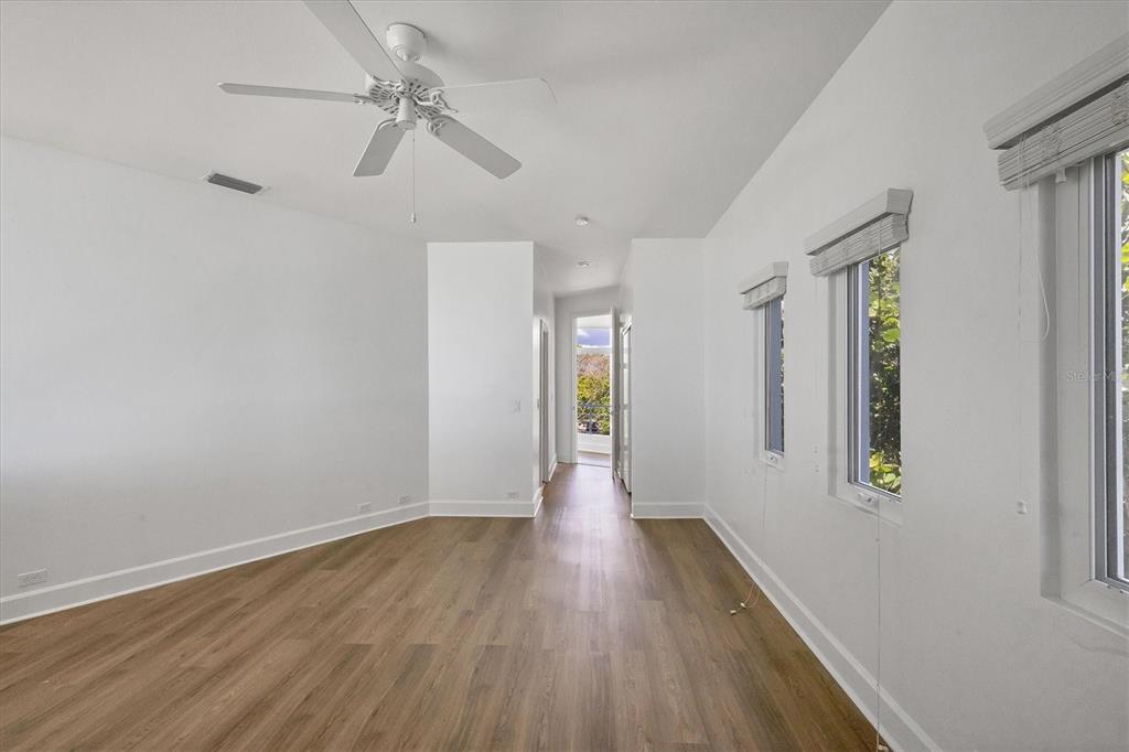 5801 Gulf Of Mexico Drive Longboat Key, FL 34228 - Photo 26 of 52 wooden floor in an empty room with a window