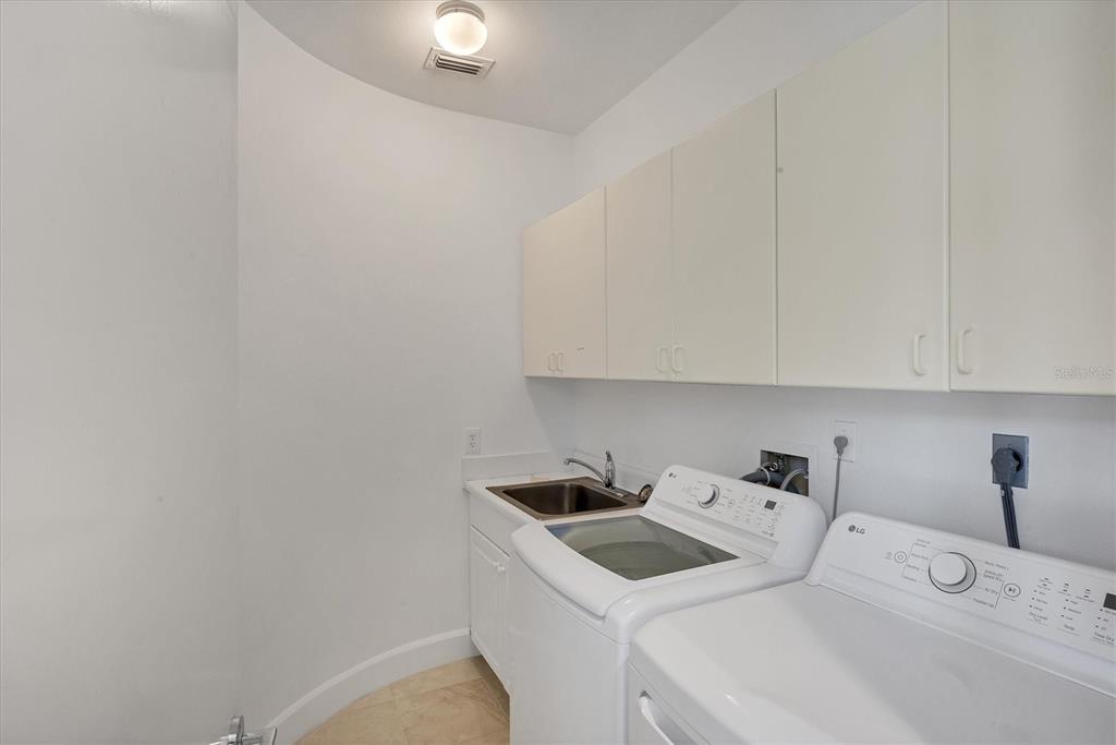 5801 Gulf Of Mexico Drive Longboat Key, FL 34228 - Photo 28 of 52 a room with a sink and cabinets