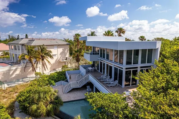aerial view of a house with a yard and balcony