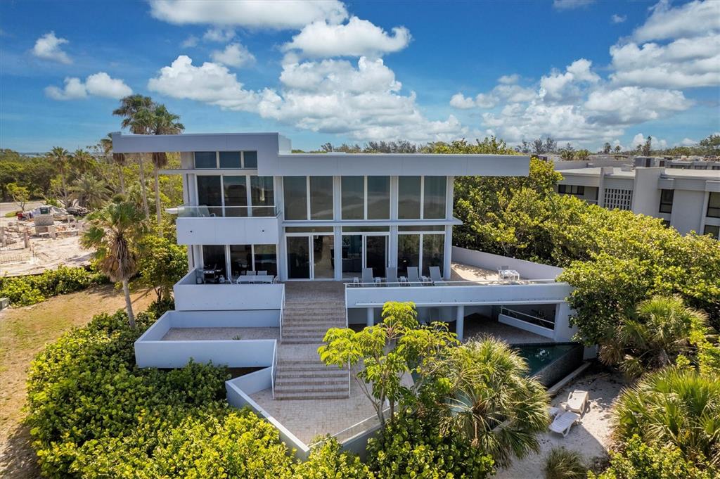 5801 Gulf Of Mexico Drive Longboat Key, FL 34228 - Photo 39 of 52 a view of a house with pool and garden