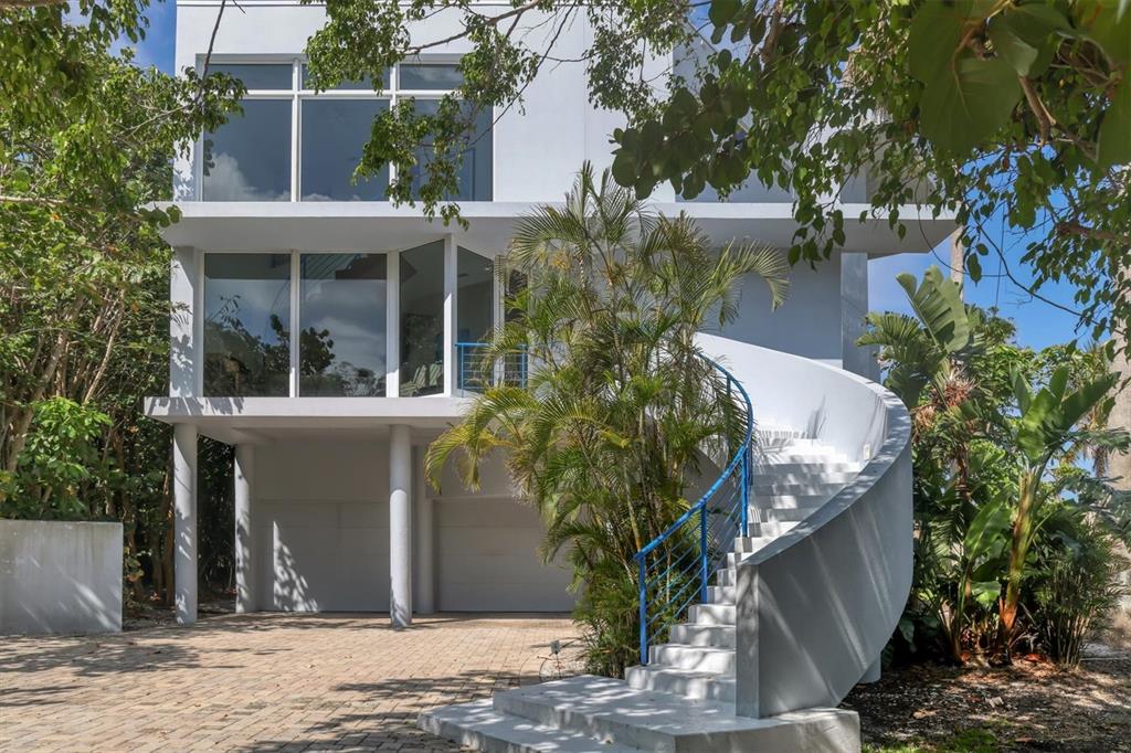 5801 Gulf Of Mexico Drive Longboat Key, FL 34228 - Photo 49 of 52 a front view of a house with garden