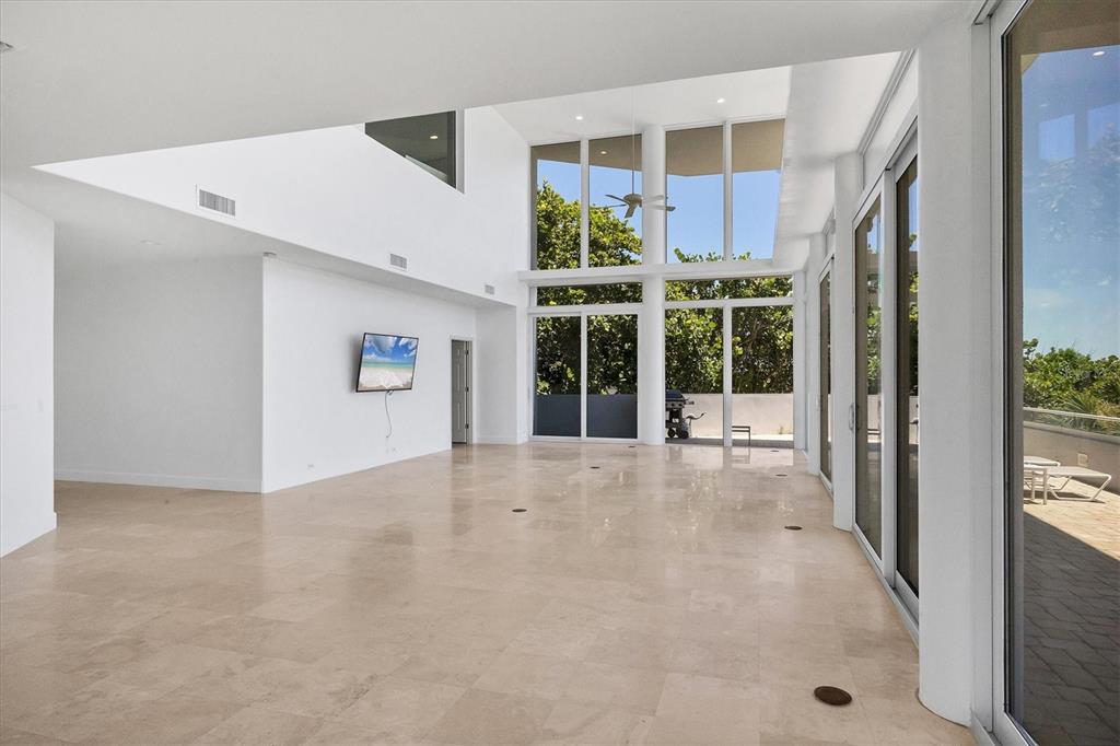 5801 Gulf Of Mexico Drive Longboat Key, FL 34228 - Photo 7 of 52 a view of a building with a floor to ceiling window and garden