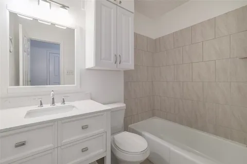 a bathroom with a sink a toilet and bathtub