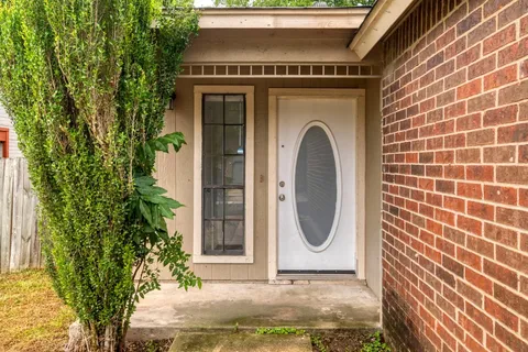 a view of a door of a house with potted plants