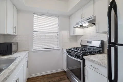 a kitchen with a stove and a refrigerator