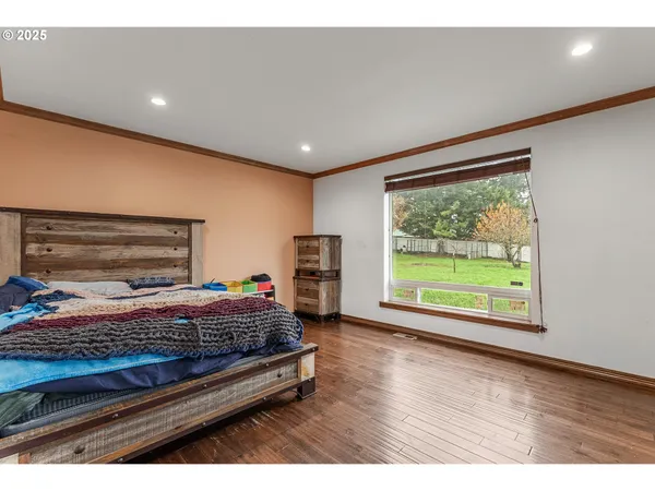 a bedroom with a bed and a large window
