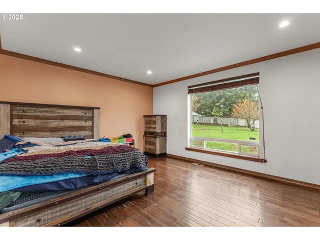 a bedroom with a bed and a large window