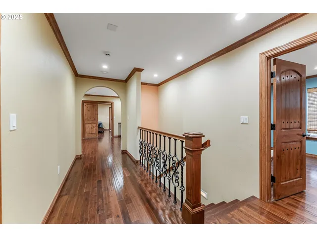 a view of hallway with wooden floor