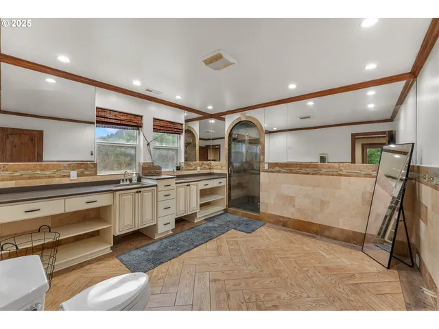 a kitchen with stainless steel appliances kitchen island granite countertop a refrigerator and a sink