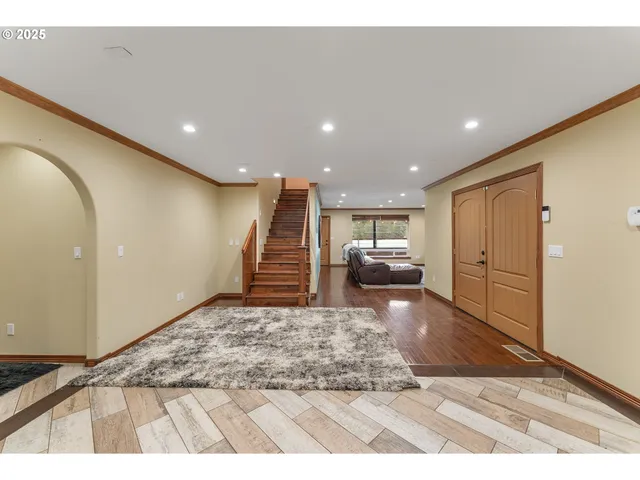 a view of a livingroom with furniture and stairs