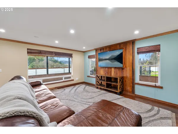 a bedroom with furniture and a large window