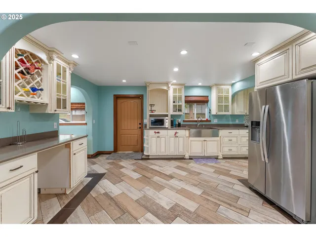 a kitchen with stainless steel appliances granite countertop a refrigerator and a sink