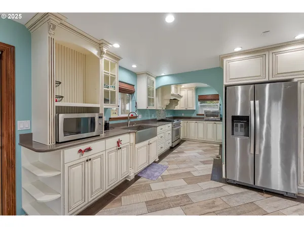 a large kitchen with cabinets and stainless steel appliances
