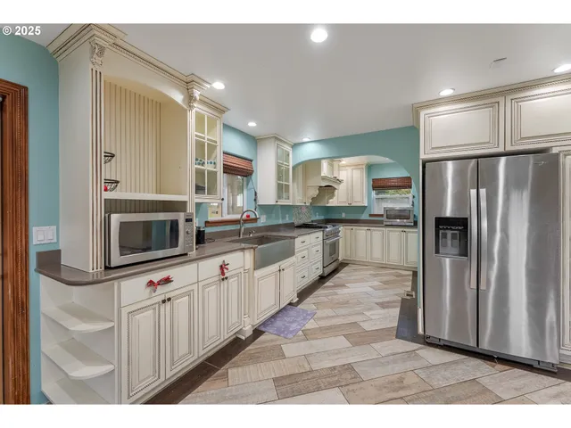 a large kitchen with cabinets and stainless steel appliances