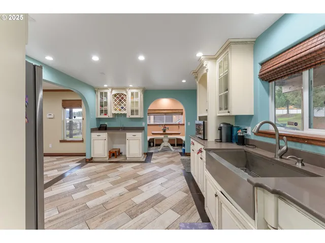 a kitchen with stainless steel appliances granite countertop a sink stove and cabinets